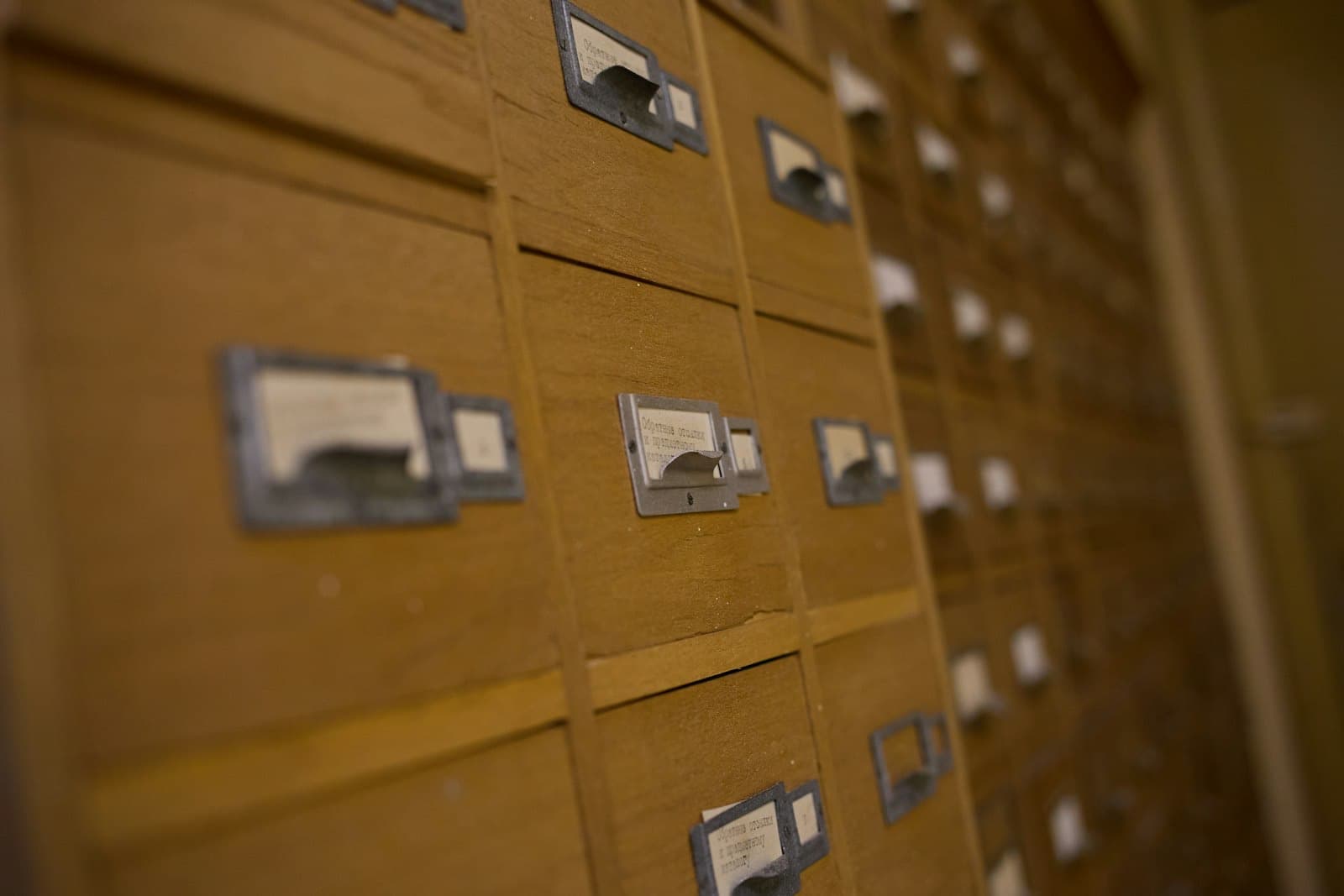 A wall of wooden card-catalogue drawers, each one hand-labelled