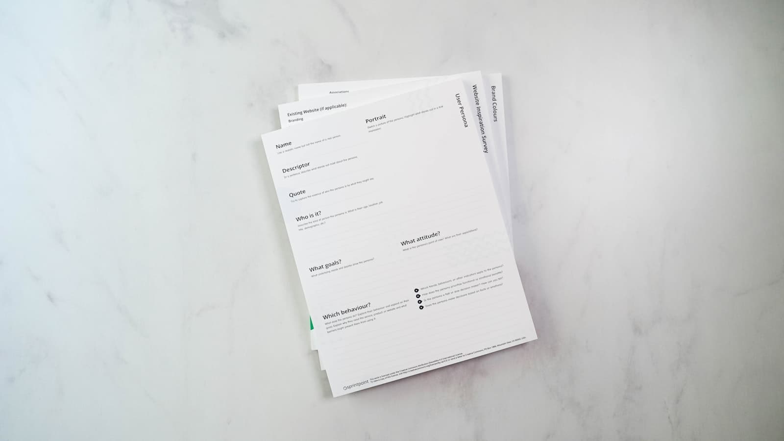 A neatly printed stack of one-page media kits on a marble desk