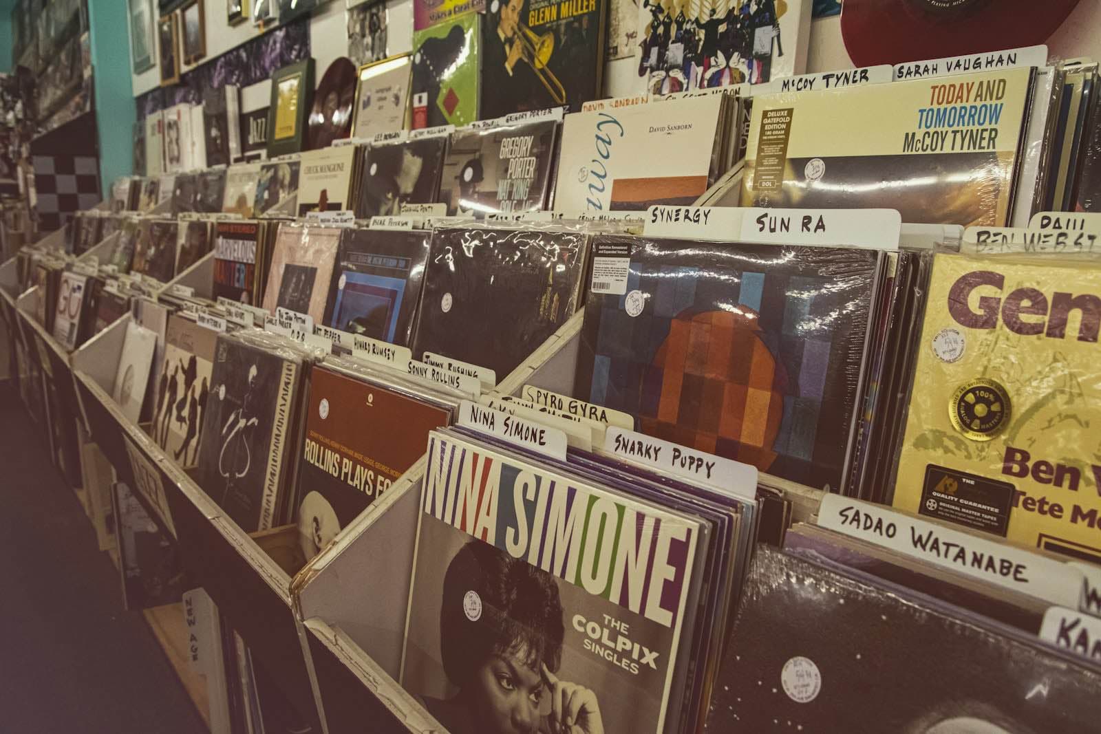 Rows of records in a store, each section marked with a hand-written divider card