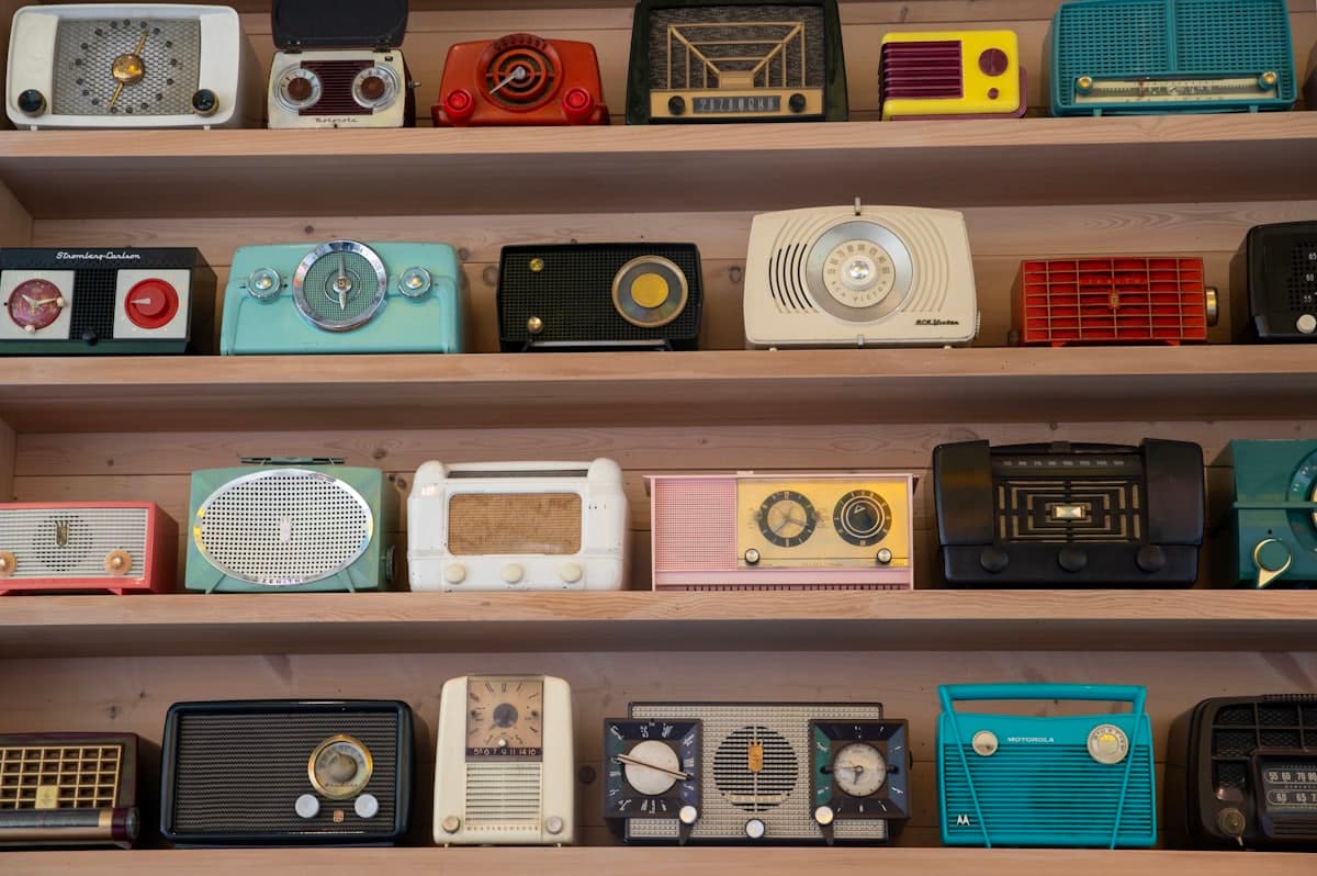Shelves lined with dozens of colorful vintage radios, each one different